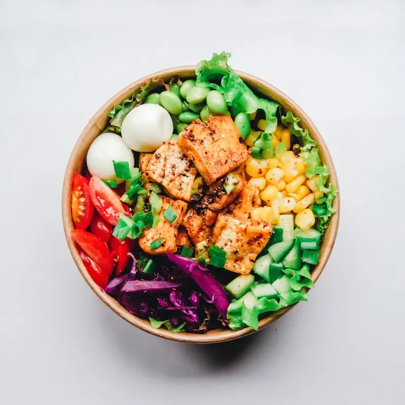 Artfully plated vegan Buddha bowl with avocado, quinoa, and roasted beets